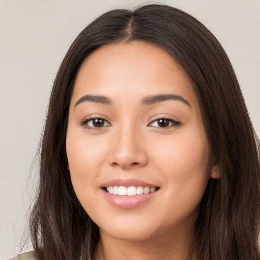 Joyful white young-adult female with long  brown hair and brown eyes