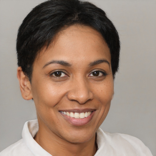Joyful latino young-adult female with short  black hair and brown eyes