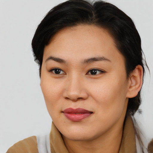 Joyful asian young-adult female with medium  brown hair and brown eyes
