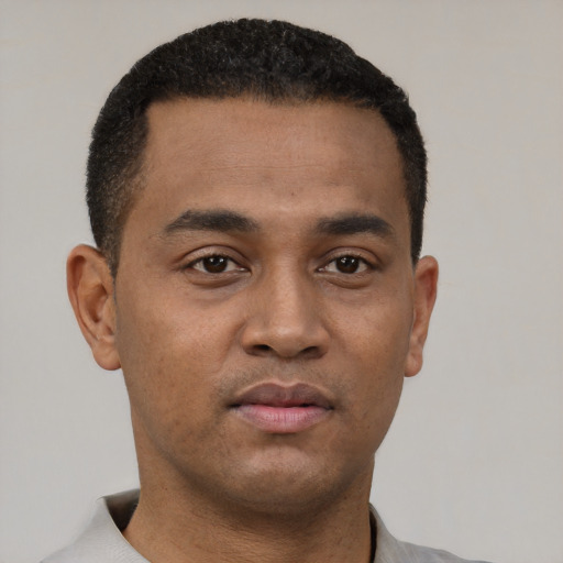 Neutral latino young-adult male with short  black hair and brown eyes