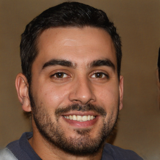 Joyful white young-adult male with short  black hair and brown eyes