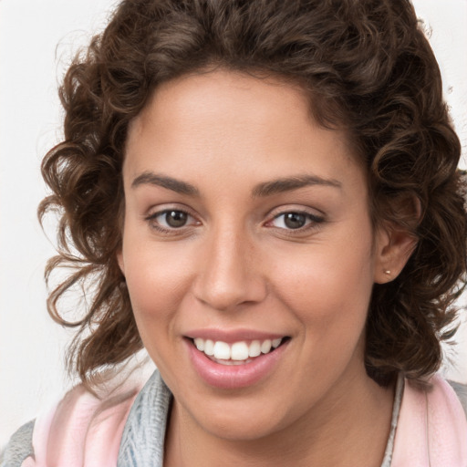 Joyful white young-adult female with medium  brown hair and blue eyes