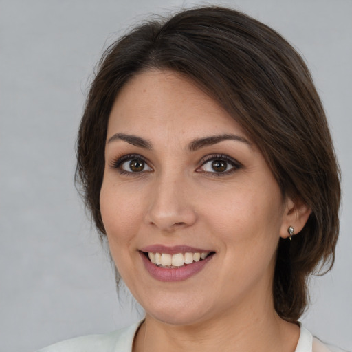 Joyful white young-adult female with medium  brown hair and brown eyes