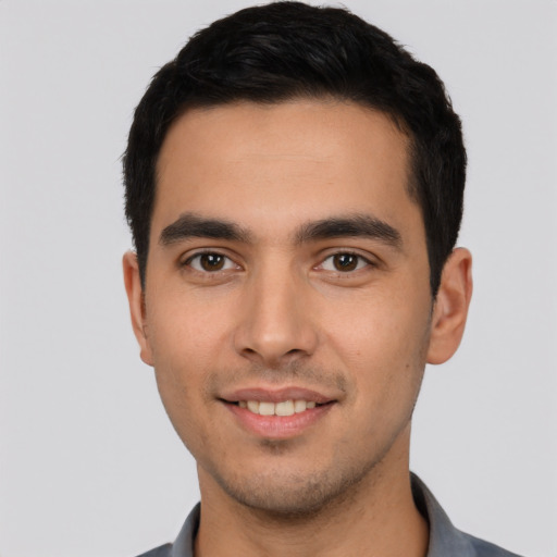 Joyful white young-adult male with short  black hair and brown eyes