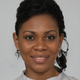 Joyful black young-adult female with short  brown hair and brown eyes