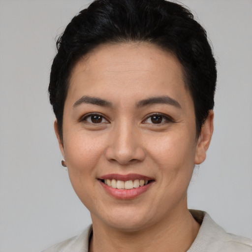 Joyful asian young-adult female with short  black hair and brown eyes