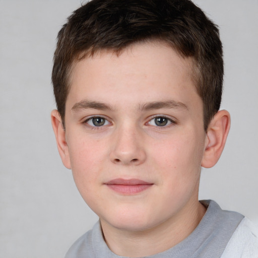 Joyful white child male with short  brown hair and brown eyes