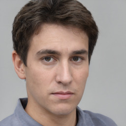 Neutral white young-adult male with short  brown hair and grey eyes