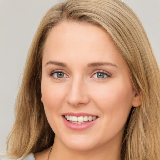 Joyful white young-adult female with long  brown hair and green eyes