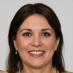 Joyful white adult female with medium  brown hair and grey eyes