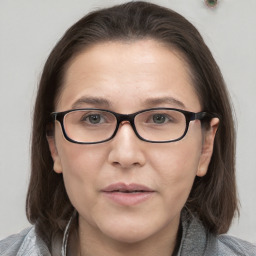 Neutral white young-adult female with medium  brown hair and grey eyes