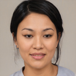 Joyful asian young-adult female with medium  black hair and brown eyes