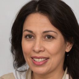 Joyful white adult female with medium  brown hair and brown eyes