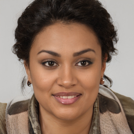 Joyful latino young-adult female with medium  brown hair and brown eyes