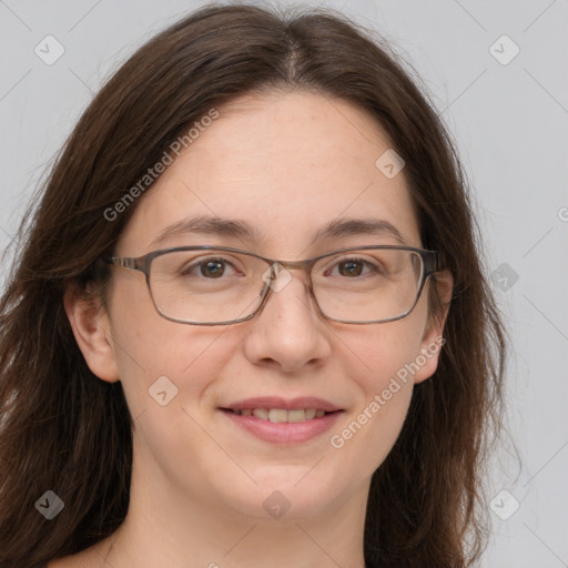 Joyful white adult female with long  brown hair and grey eyes