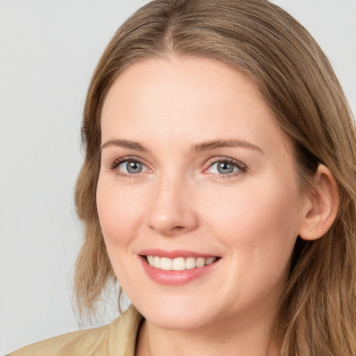 Joyful white young-adult female with long  brown hair and blue eyes