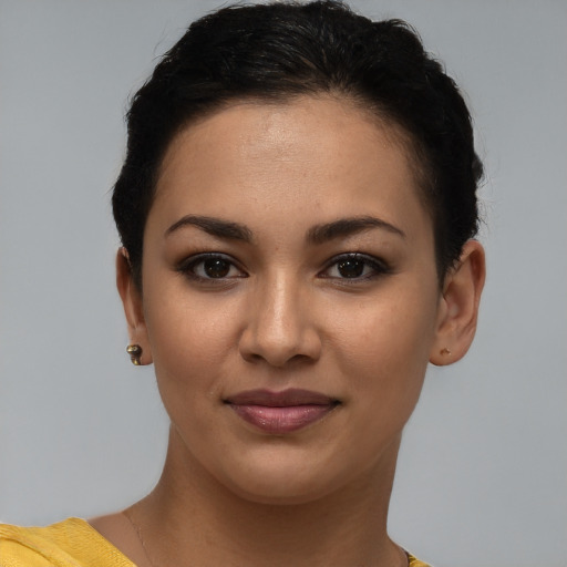 Joyful latino young-adult female with short  brown hair and brown eyes