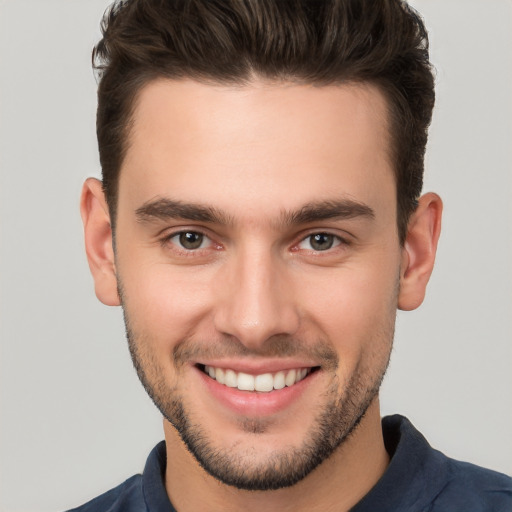 Joyful white young-adult male with short  brown hair and brown eyes