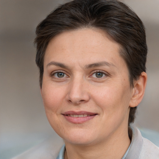 Joyful white adult female with short  brown hair and brown eyes