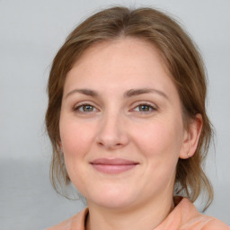 Joyful white young-adult female with medium  brown hair and blue eyes