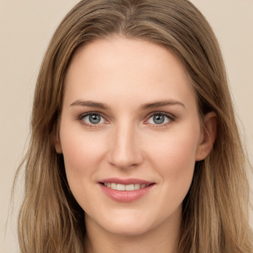 Joyful white young-adult female with long  brown hair and grey eyes