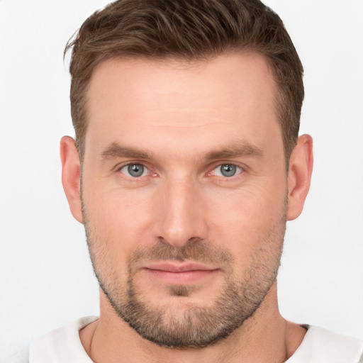 Joyful white young-adult male with short  brown hair and grey eyes