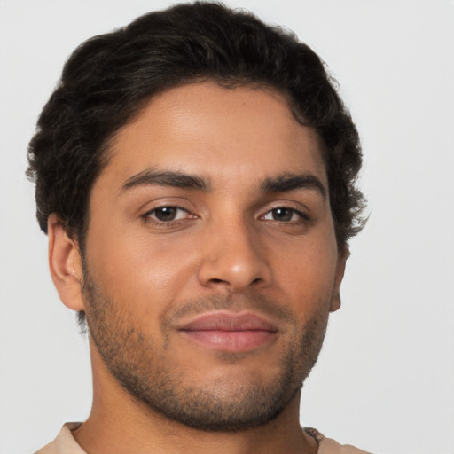 Joyful latino young-adult male with short  brown hair and brown eyes