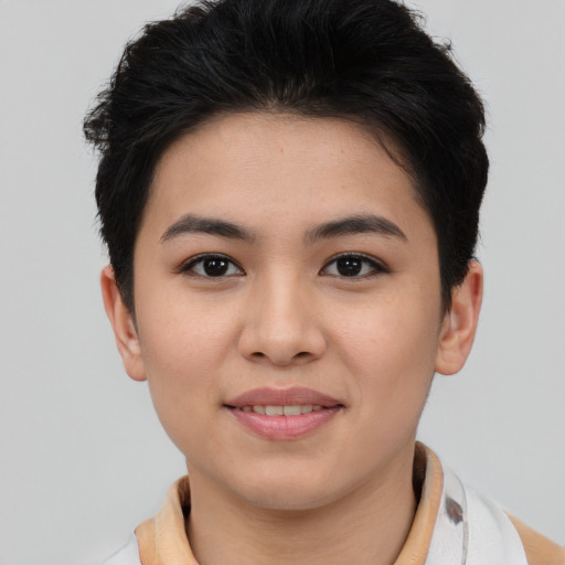 Joyful asian young-adult female with short  brown hair and brown eyes