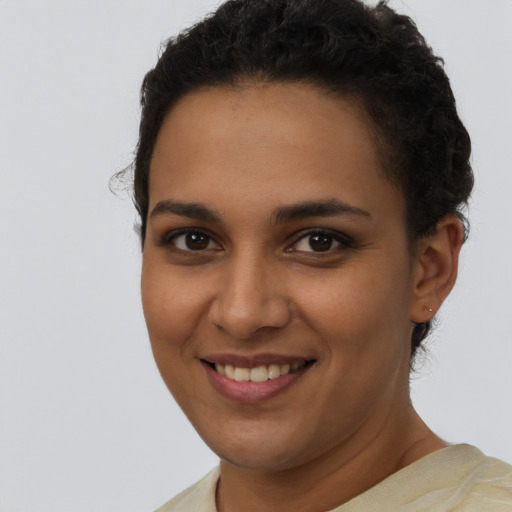 Joyful latino young-adult female with short  brown hair and brown eyes