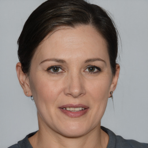 Joyful white adult female with medium  brown hair and brown eyes