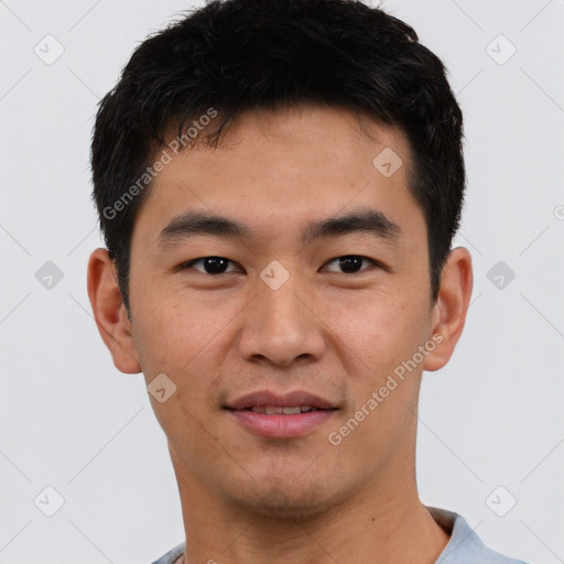 Joyful asian young-adult male with short  black hair and brown eyes