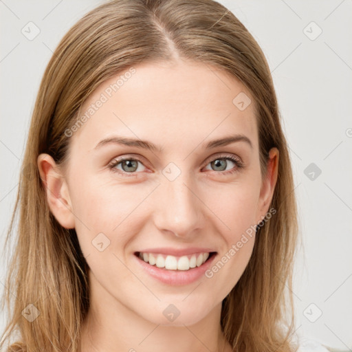 Joyful white young-adult female with long  brown hair and blue eyes