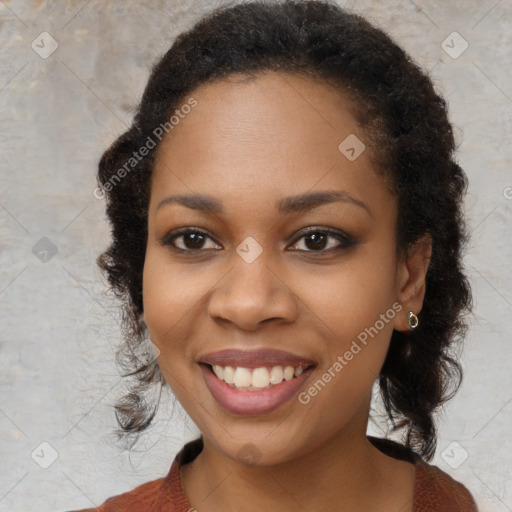 Joyful black young-adult female with long  brown hair and brown eyes