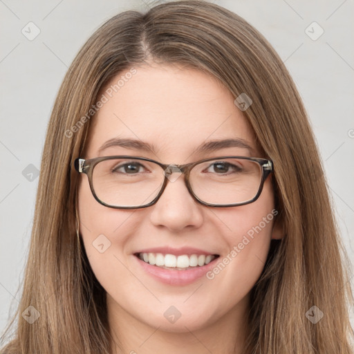 Joyful white young-adult female with long  brown hair and green eyes