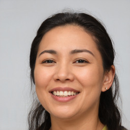 Joyful asian young-adult female with long  brown hair and brown eyes