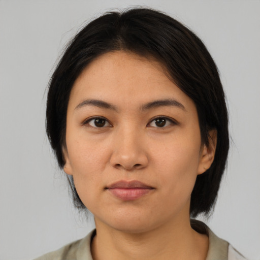 Neutral asian young-adult female with medium  brown hair and brown eyes