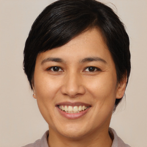 Joyful asian young-adult female with medium  brown hair and brown eyes