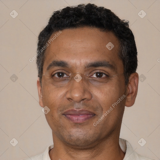 Joyful black adult male with short  black hair and brown eyes