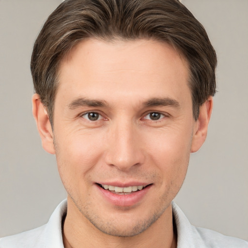 Joyful white young-adult male with short  brown hair and brown eyes