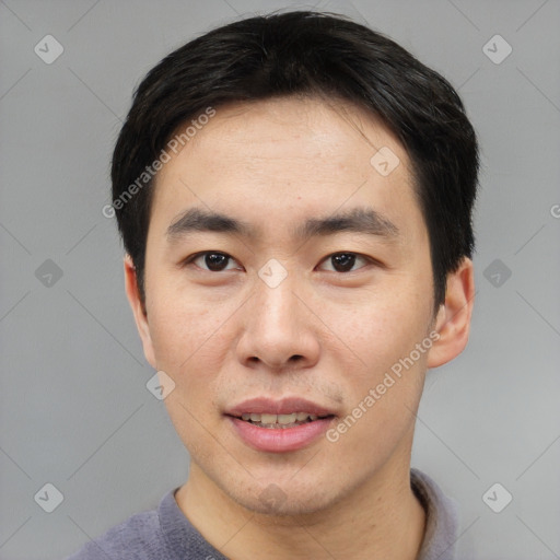 Joyful asian young-adult male with short  black hair and brown eyes