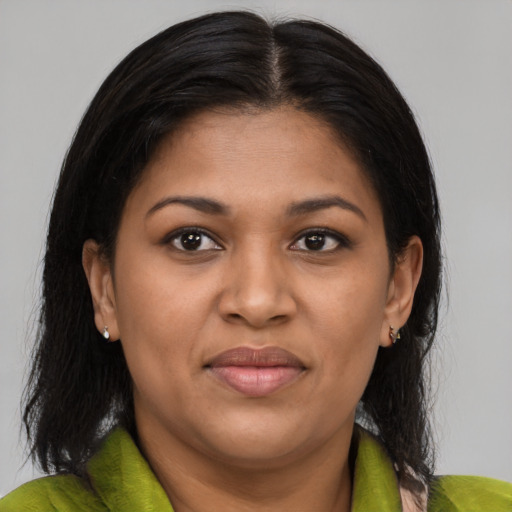Joyful black young-adult female with medium  brown hair and brown eyes