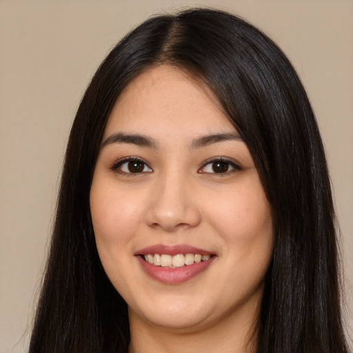 Joyful white young-adult female with long  black hair and brown eyes