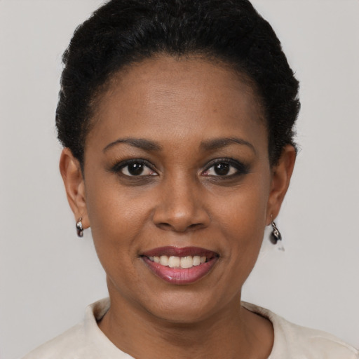 Joyful black young-adult female with short  brown hair and brown eyes