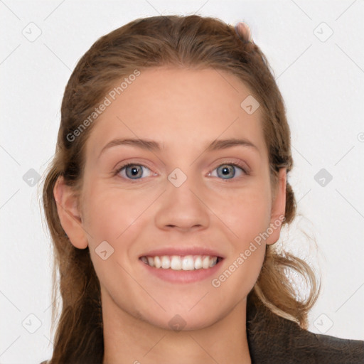 Joyful white young-adult female with long  brown hair and blue eyes