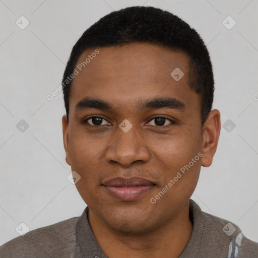 Joyful black young-adult male with short  black hair and brown eyes