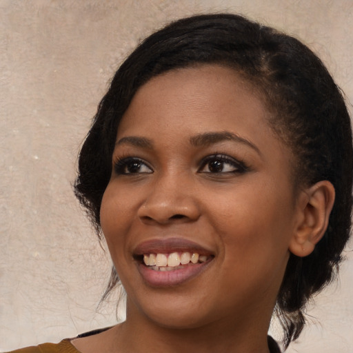 Joyful black young-adult female with medium  black hair and brown eyes