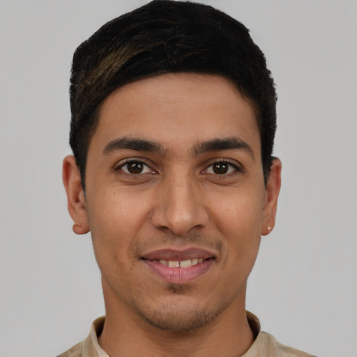 Joyful latino young-adult male with short  black hair and brown eyes