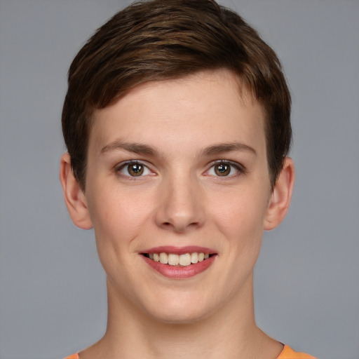 Joyful white young-adult female with short  brown hair and grey eyes