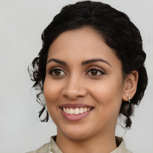 Joyful latino young-adult female with medium  black hair and brown eyes
