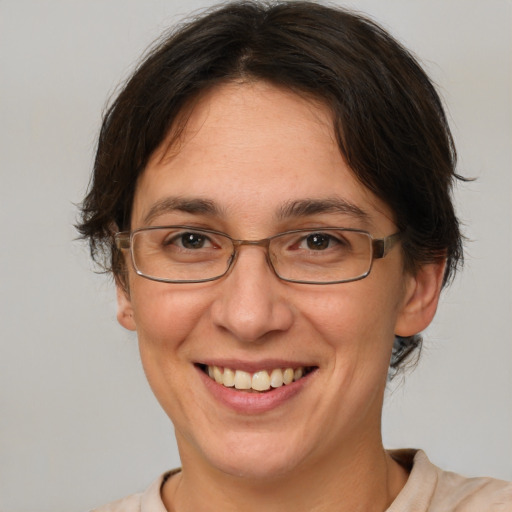 Joyful white adult female with medium  brown hair and brown eyes